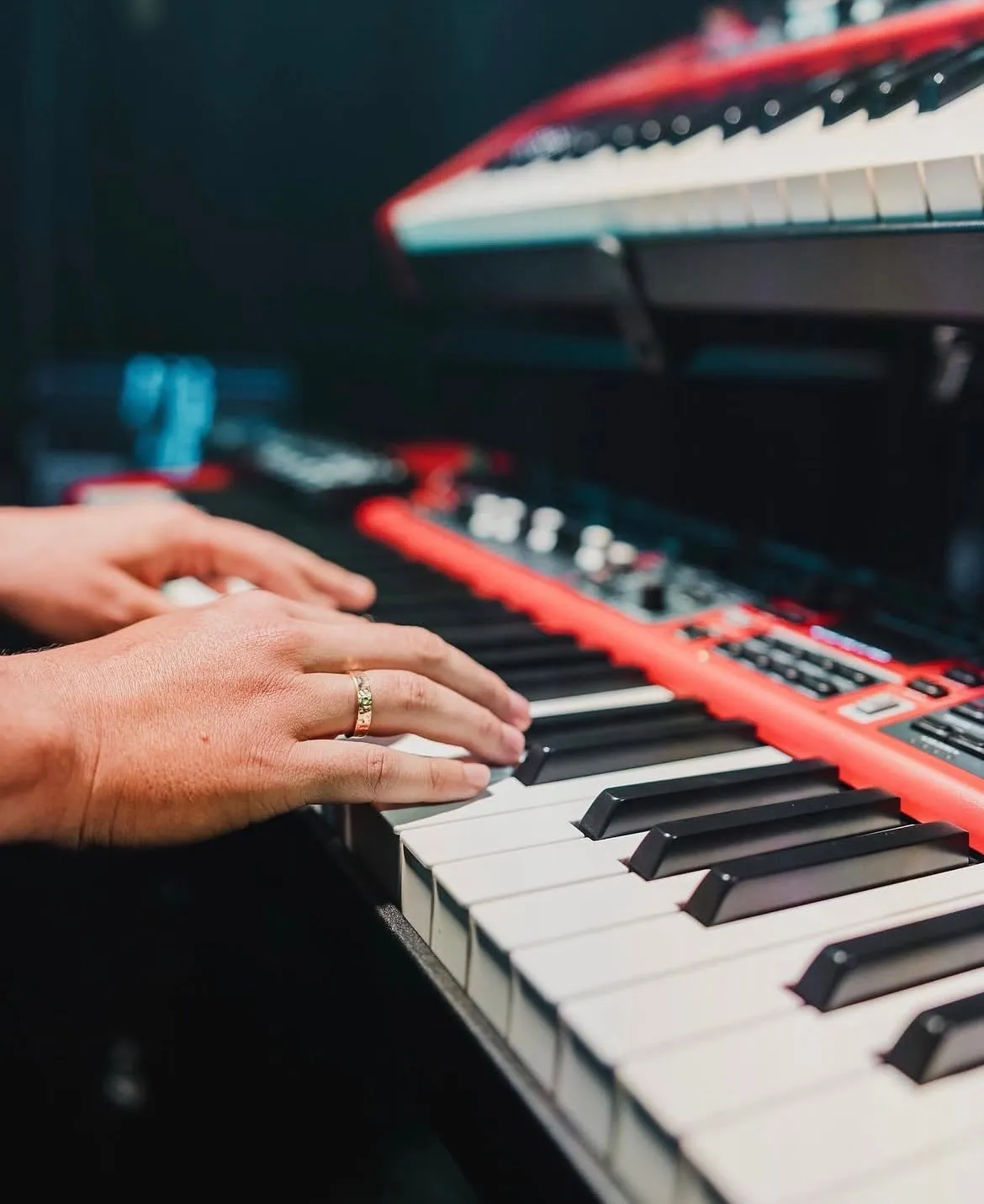Close-up of Sergio Bustos's hands playing a Nord Stage keyboard